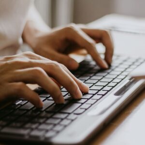 Woman typing on keyboard