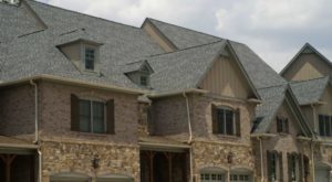 A large residence with a new asphalt shingle roof.