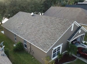 An aerial view of a client's home with brand-new asphalt shingle roofing.