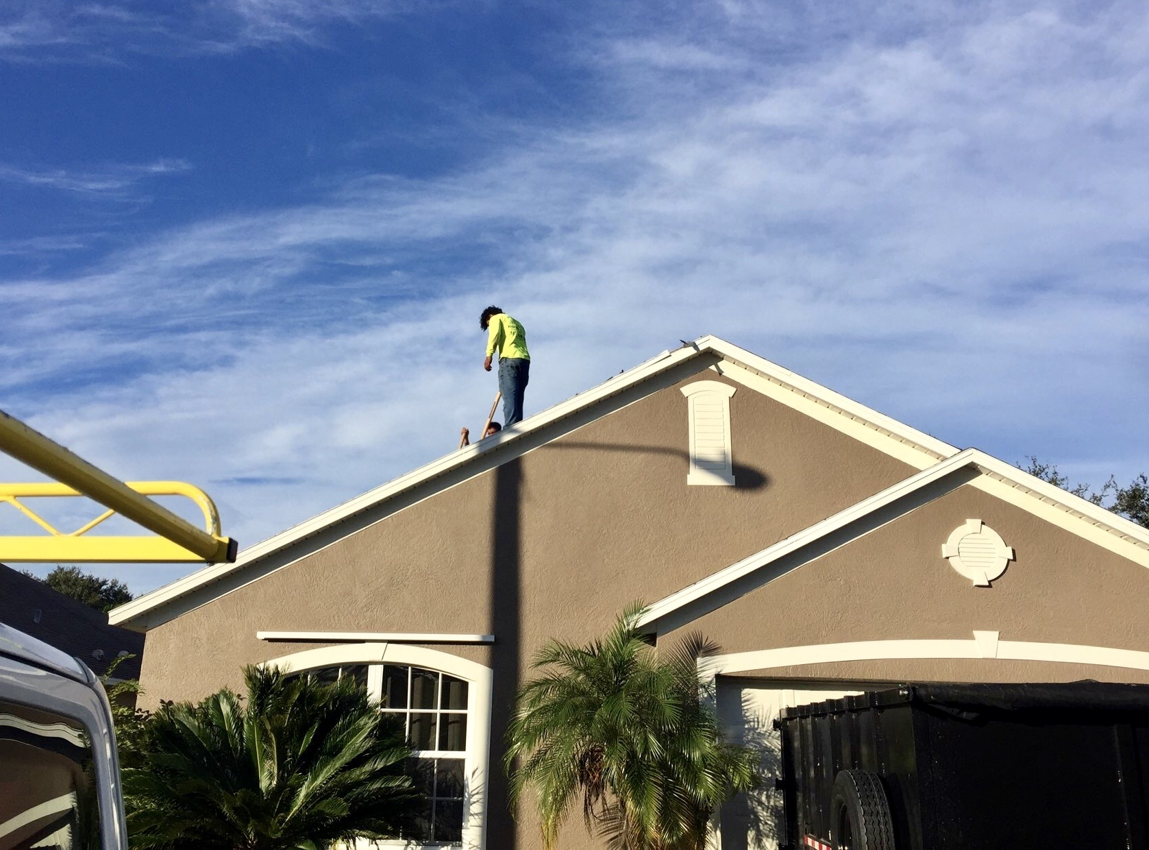 A Pit Crew team member on a client's roof