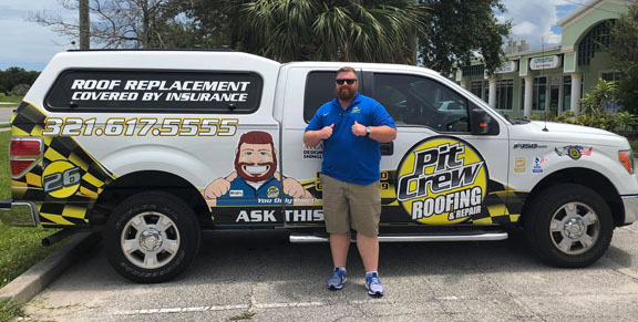 A Pit Crew employee with our new truck wrap